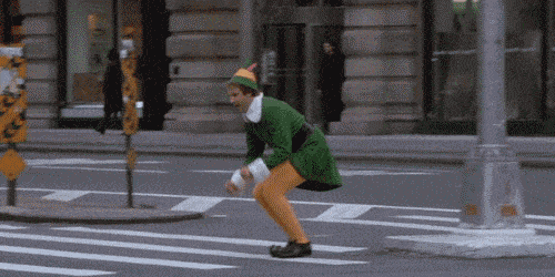a man in an elf costume hops across the street
