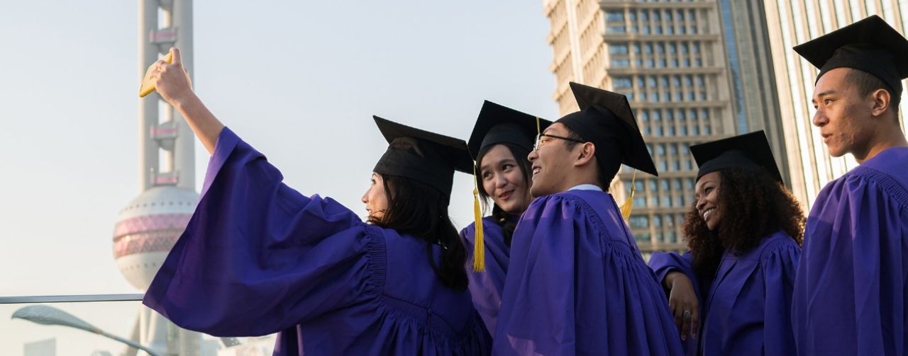 Graduating NYU Shanghai students pose for a selfie