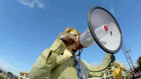 man yelling into a megaphone