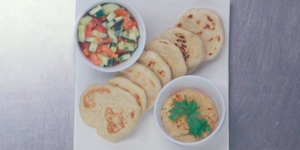 Grilled pita bread, hummus, and Israeli salad