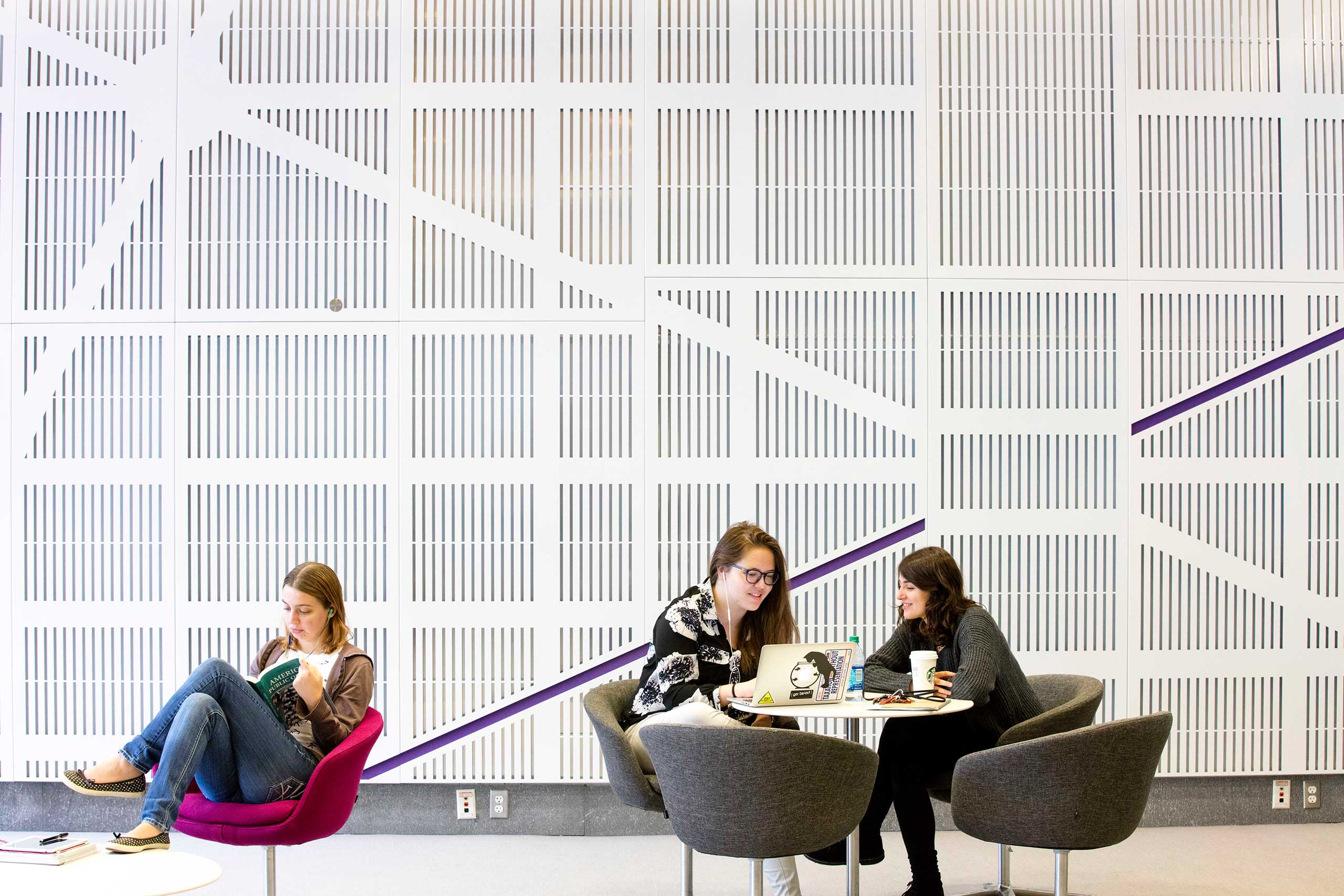 [Students in the lobby of the NYU Washington, DC, center studying.]