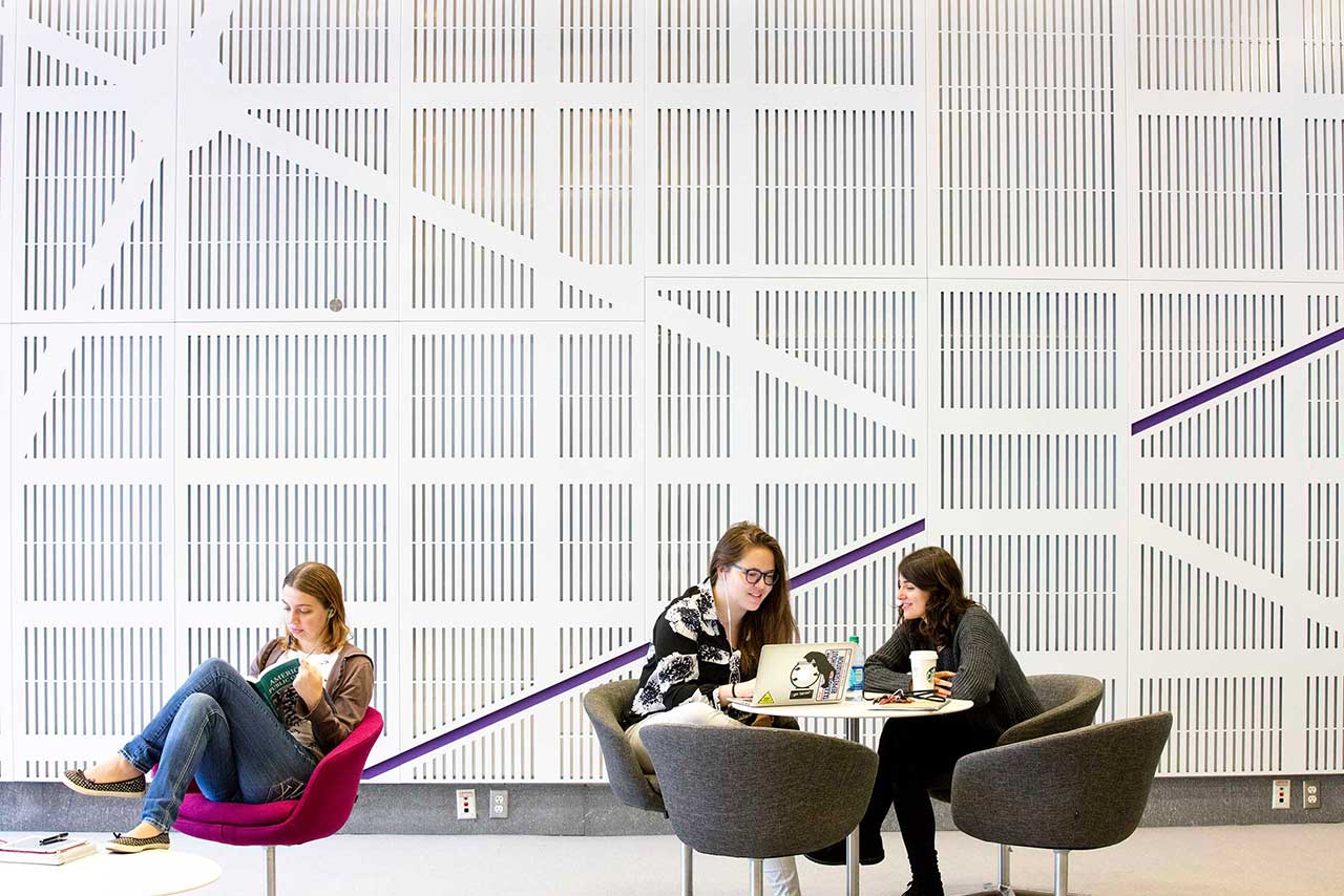 Students in the lobby of the NYU Washington, DC, center studying.