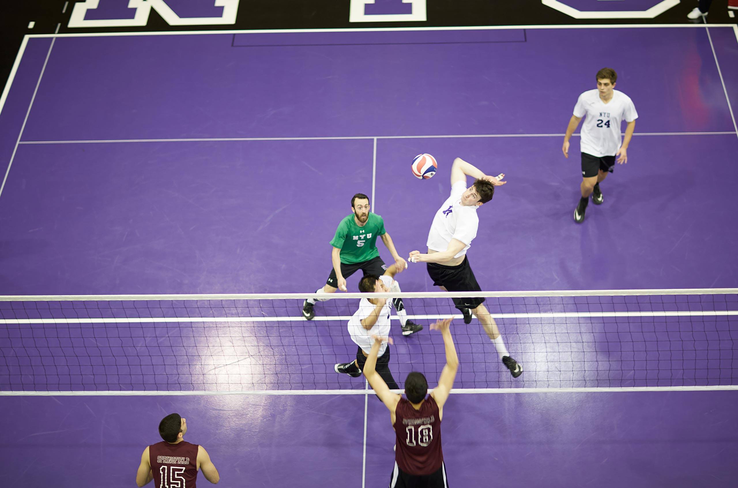 volleyball players on a purple court