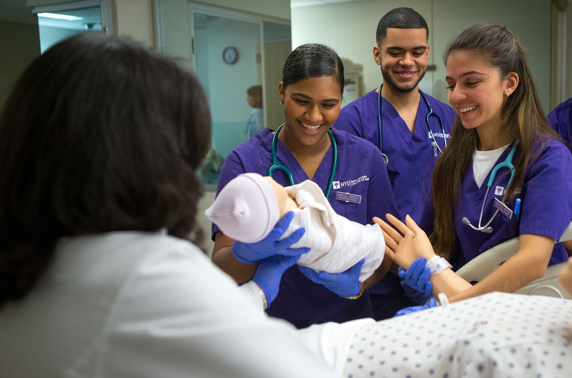 Nursing students practice handling new borns in NYU's simulation lab