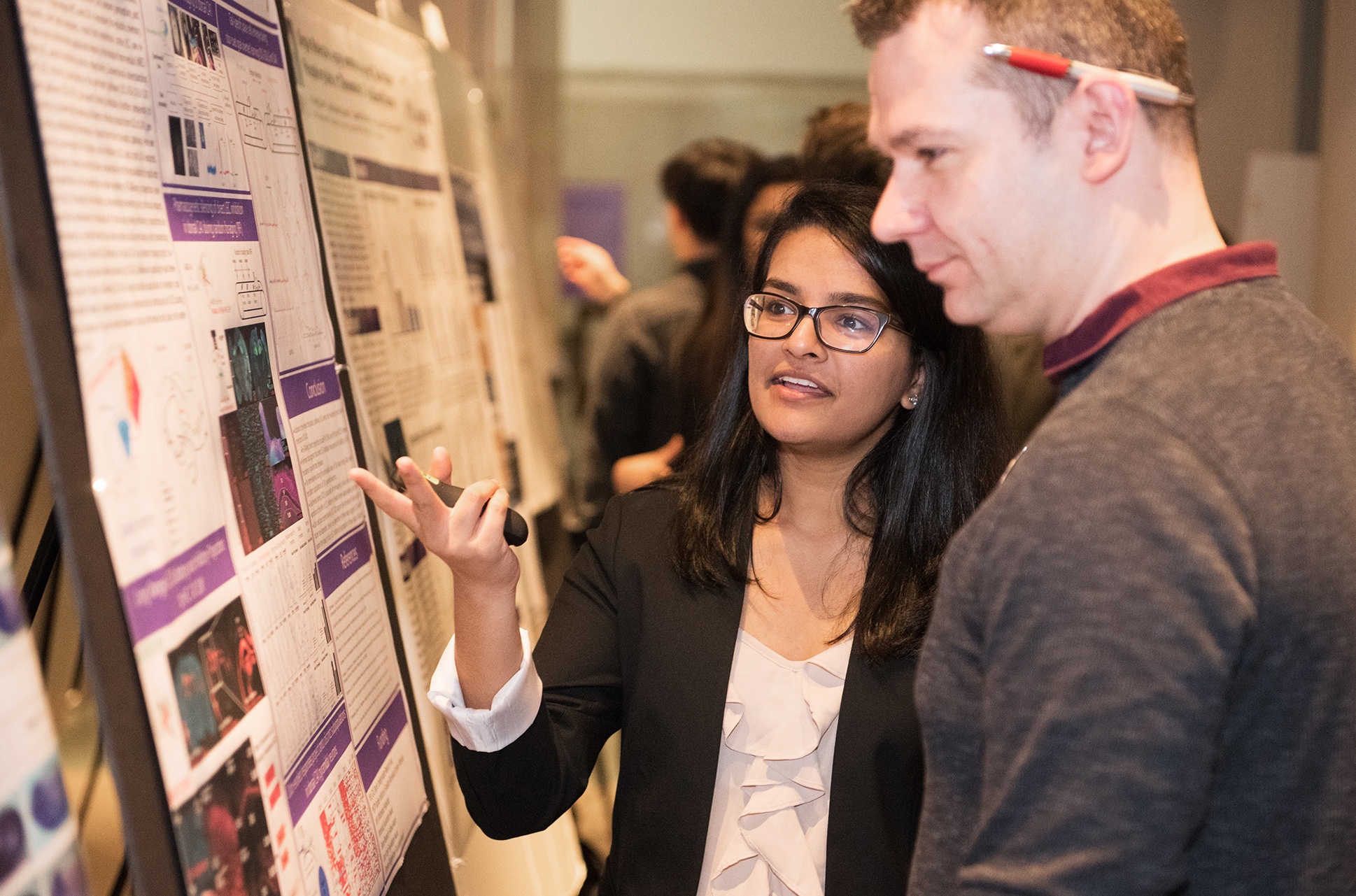 A female student showcases her research.
