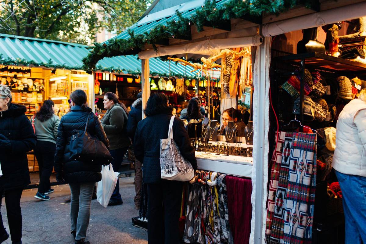 People shopping at the Union Square Holiday Market booths.