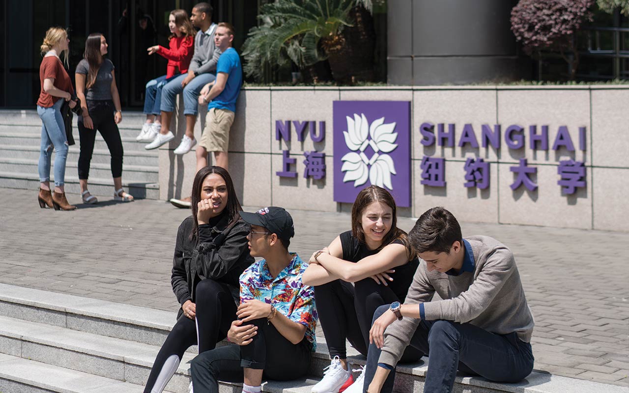 Students sitting outside of NYU Shanghai.