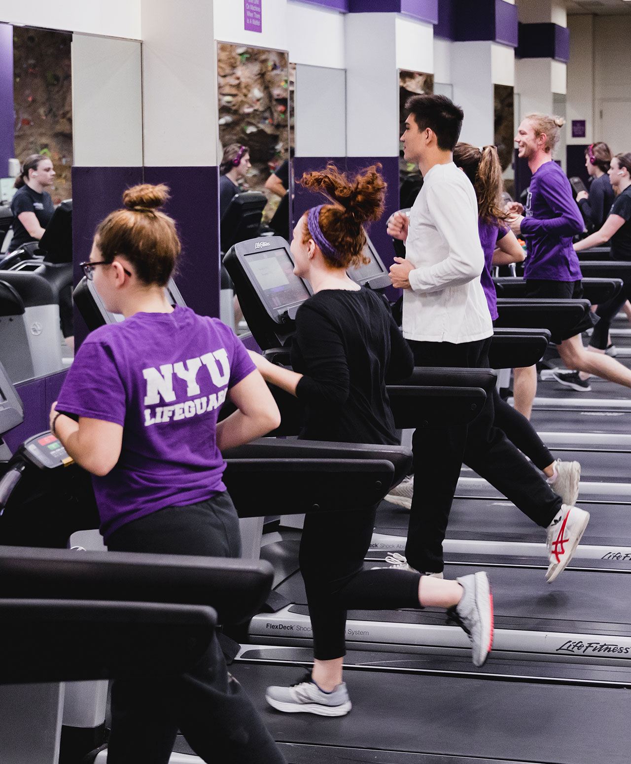 A group of students running on treadmills.