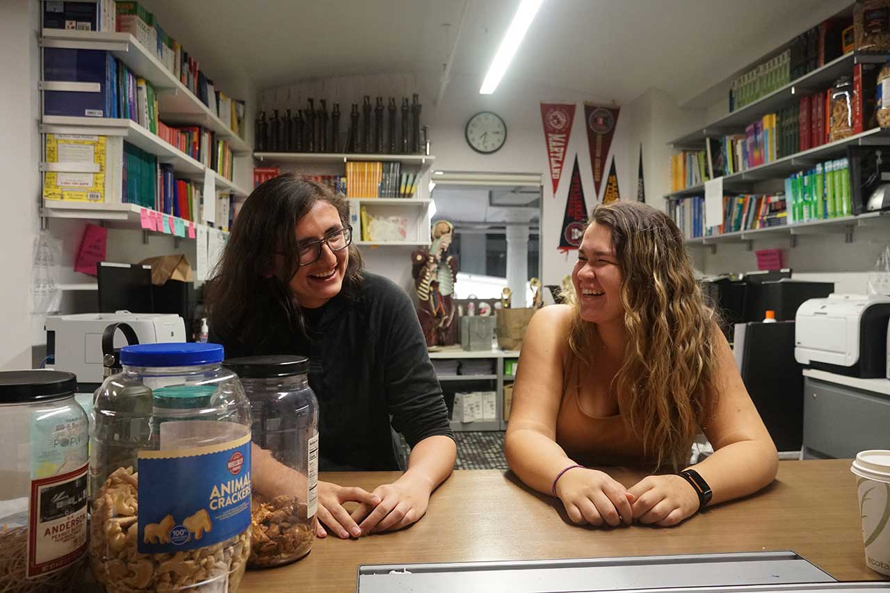 Blue Cervantes and Paige Cook, respectively, laughing at a Native American and Indigenous Student Group meeting.