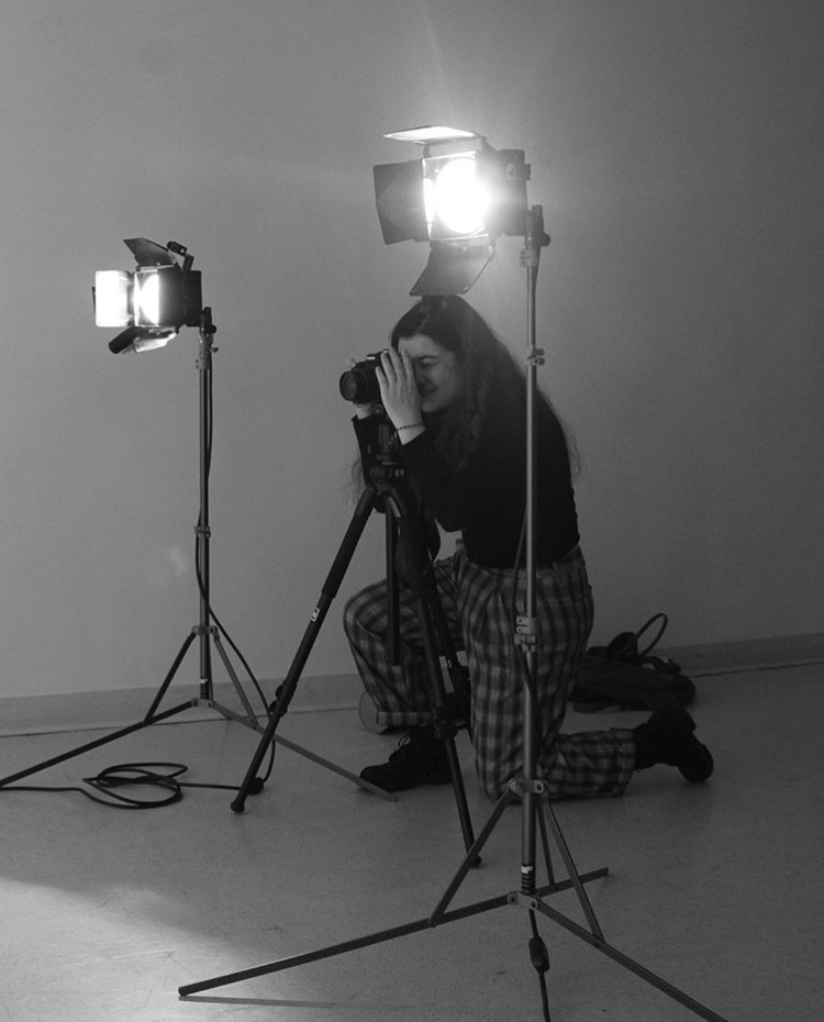 A female student taking a photograph.