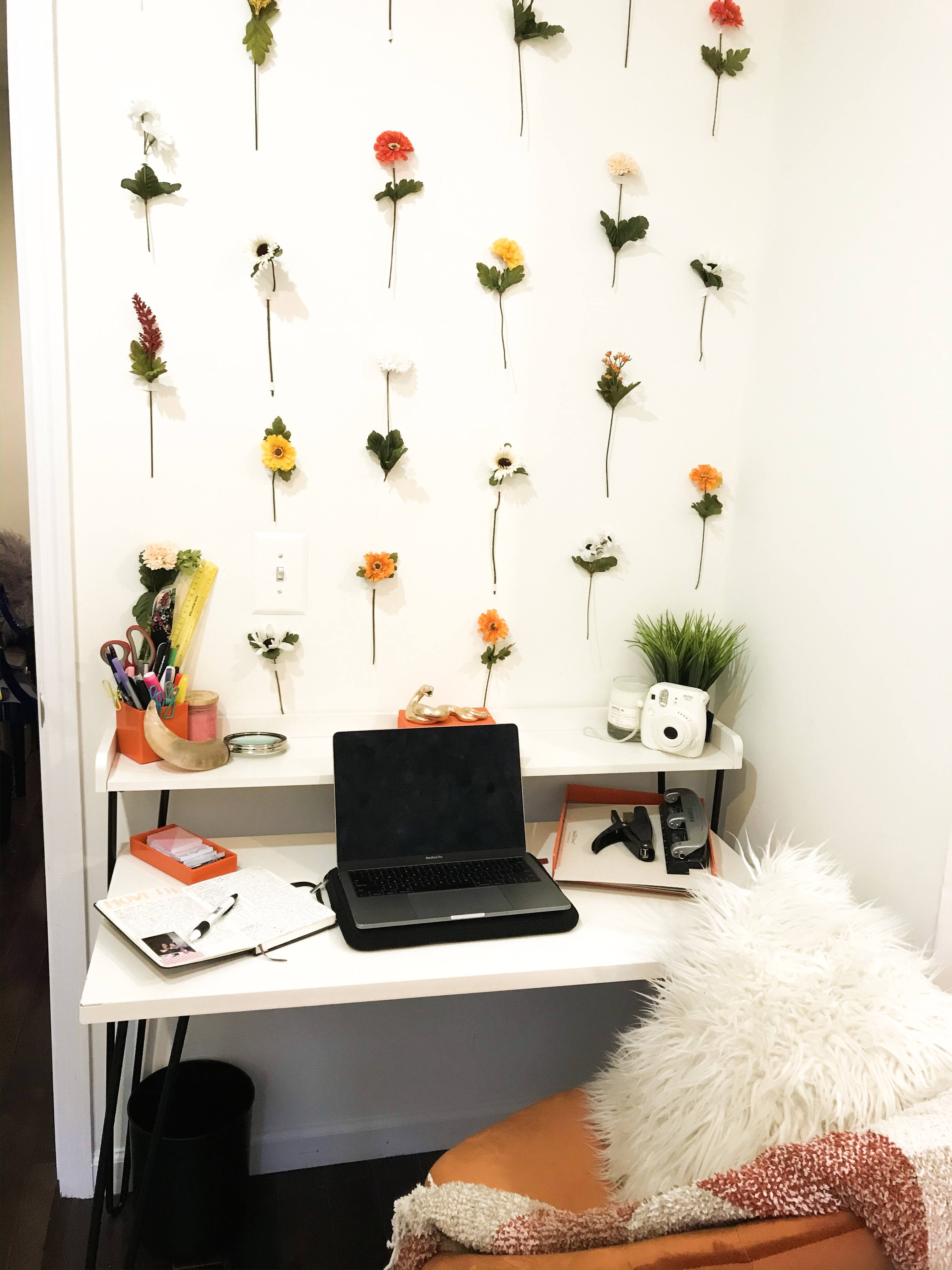 Desk in front of a decorated wall.