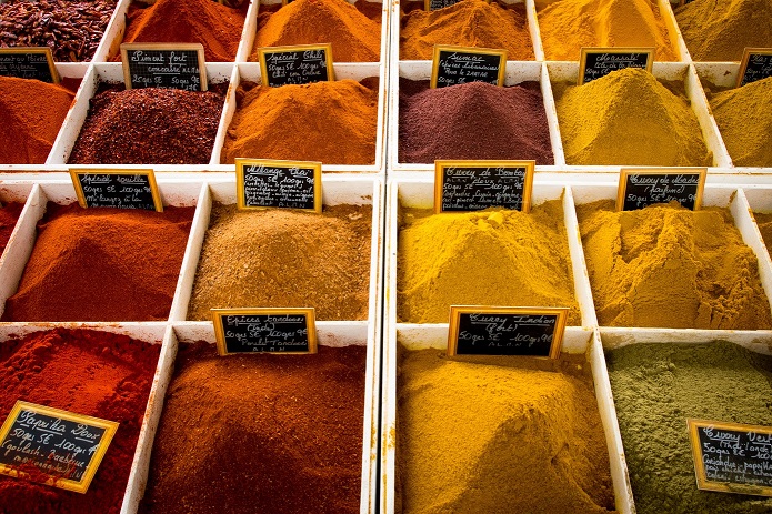 Rows of red, yellow, orange, and green spices.