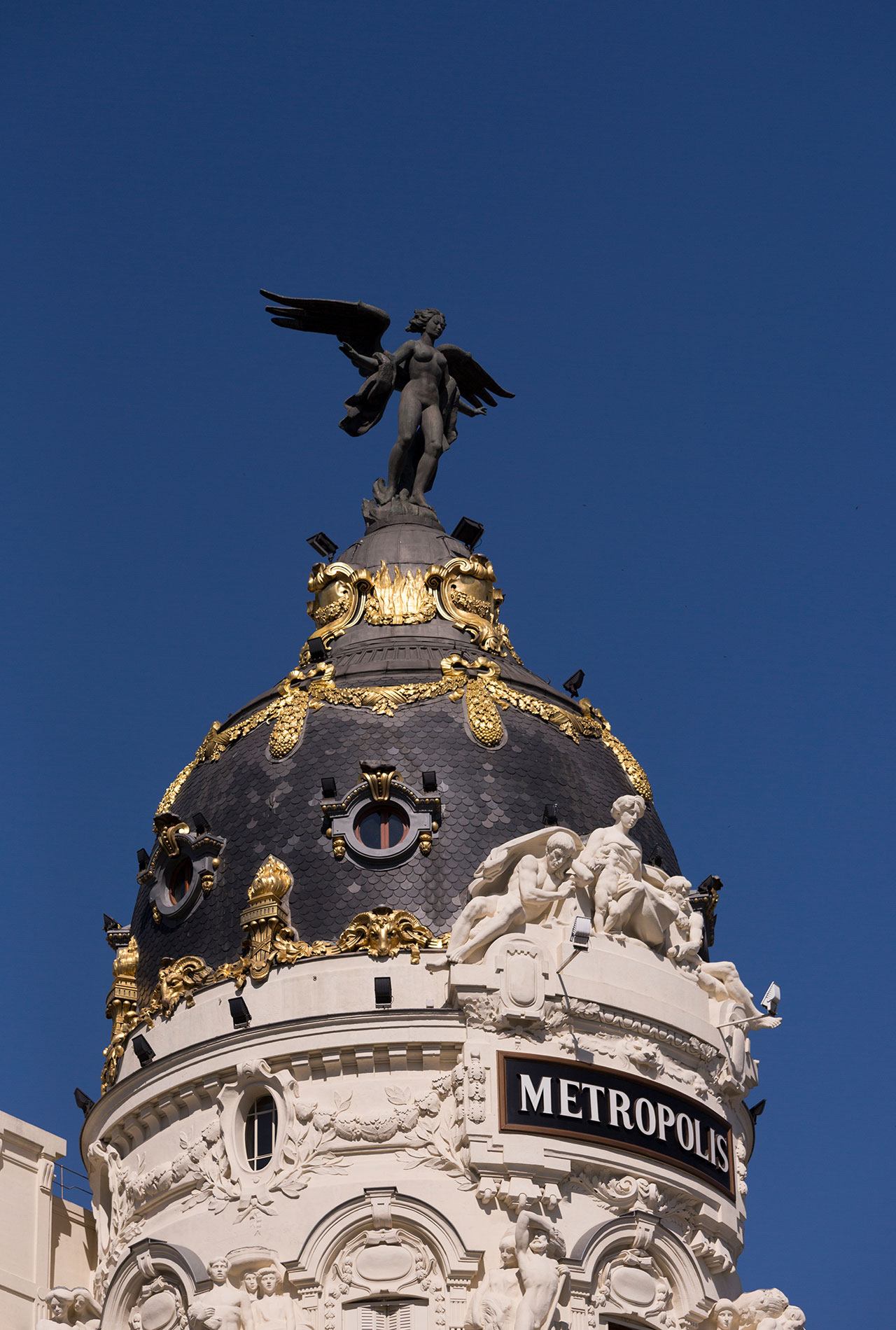 The top of a building in Madrid with ornate detailing.