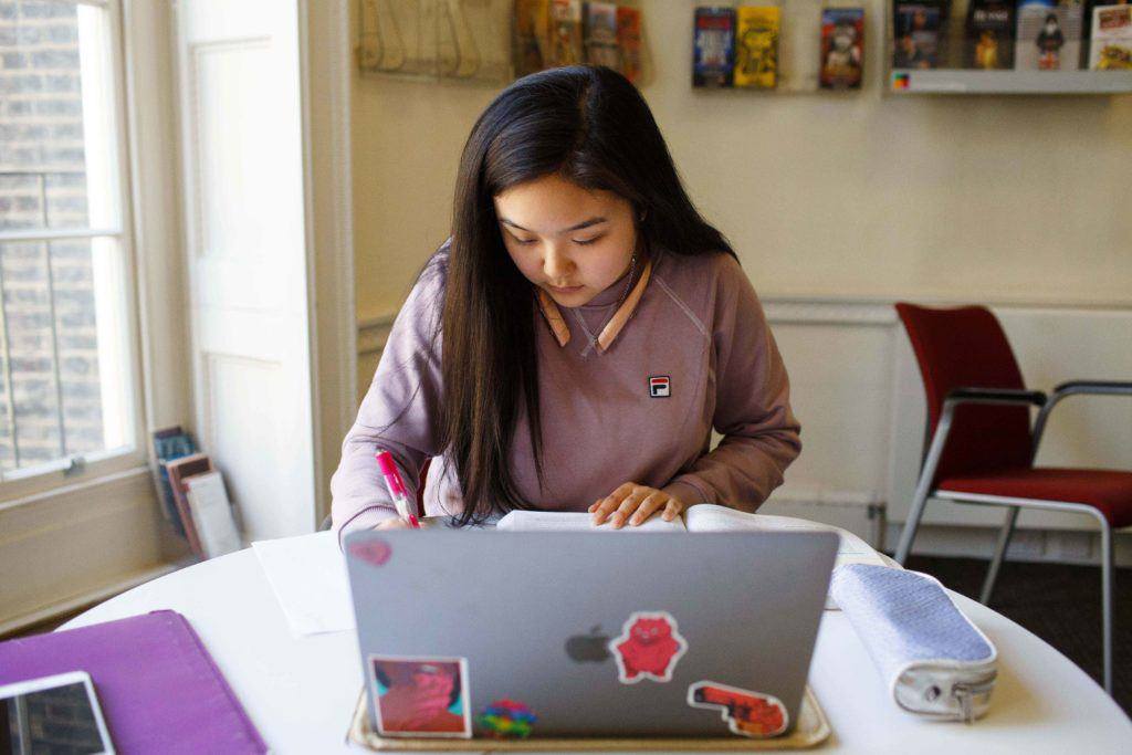 A student working on a laptop.