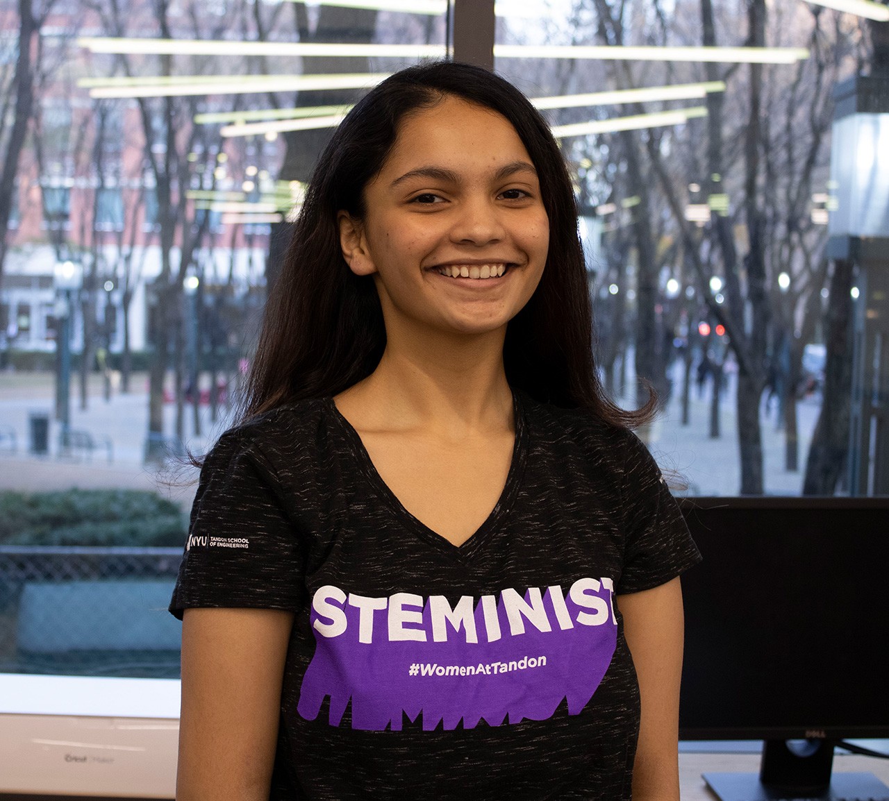 A student, who is a member of STEMinist, smiling.