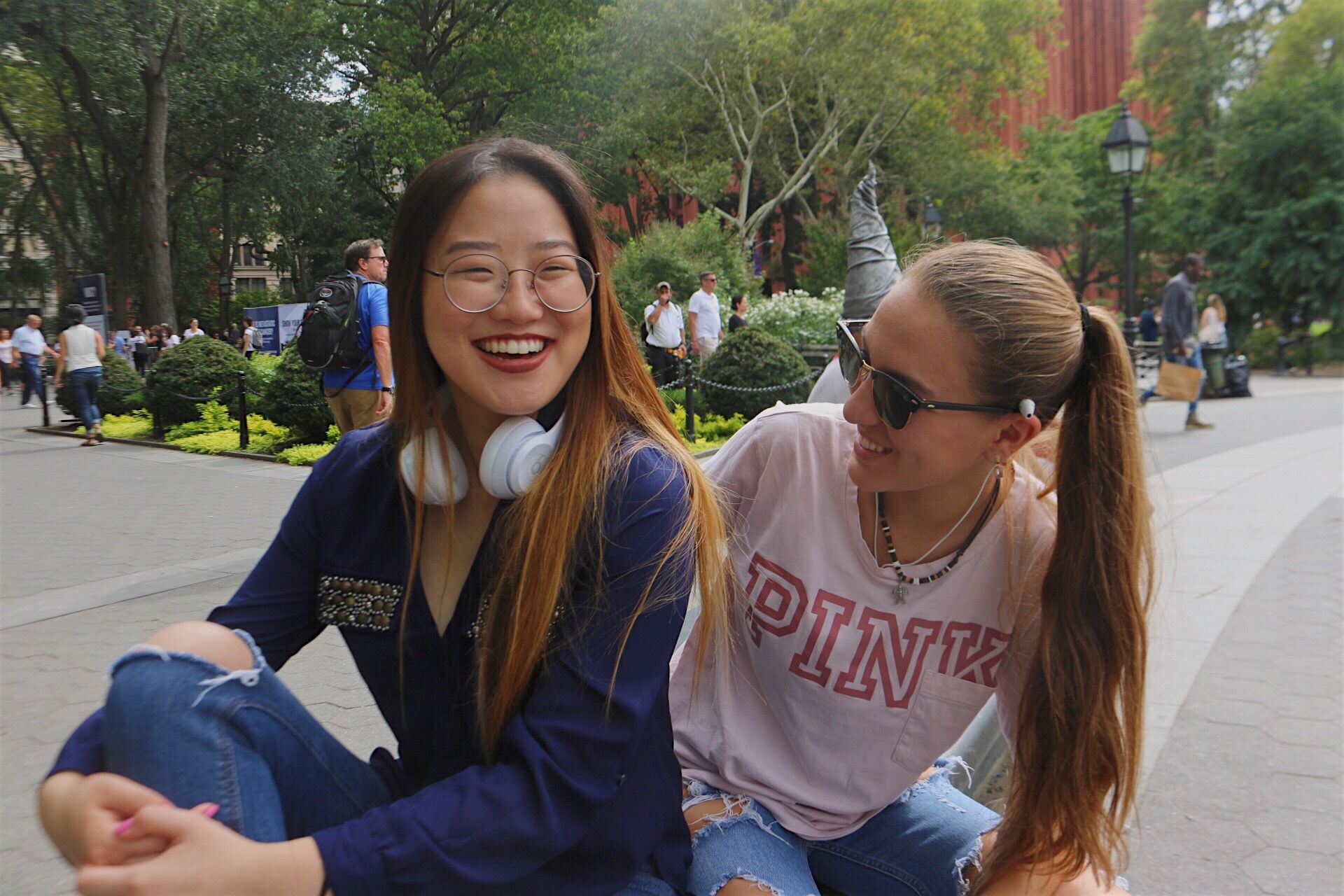 Two students smiling in Washington Square Park.