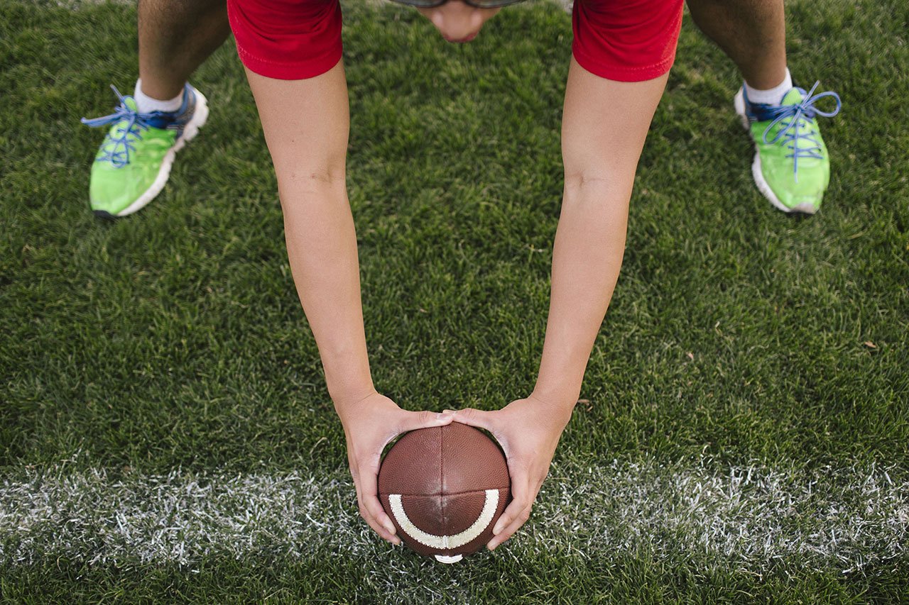 athlete holding a football