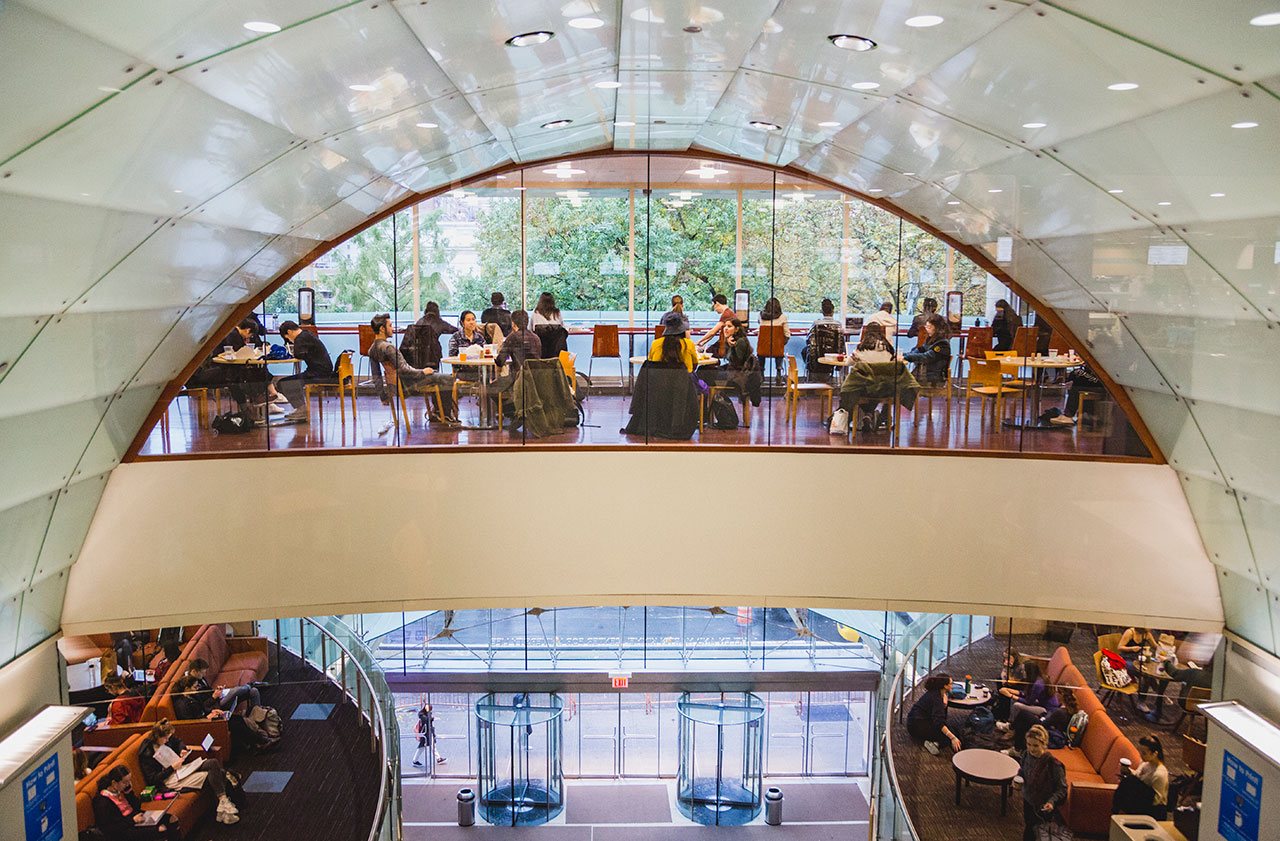 Students spending time in the lounge and study areas of the Kimmel center.