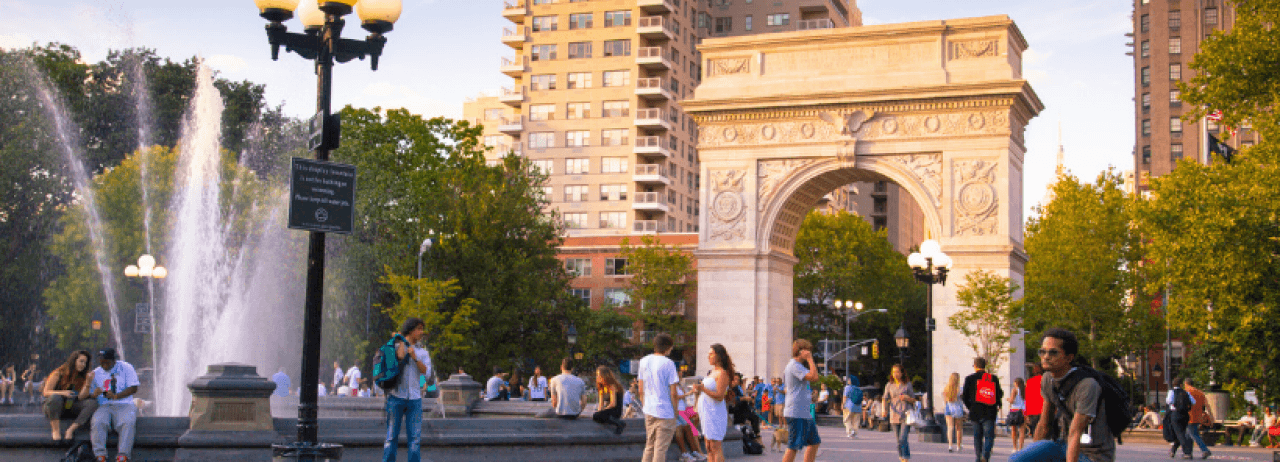 The Washington Square Arch and fountain at sunset.
