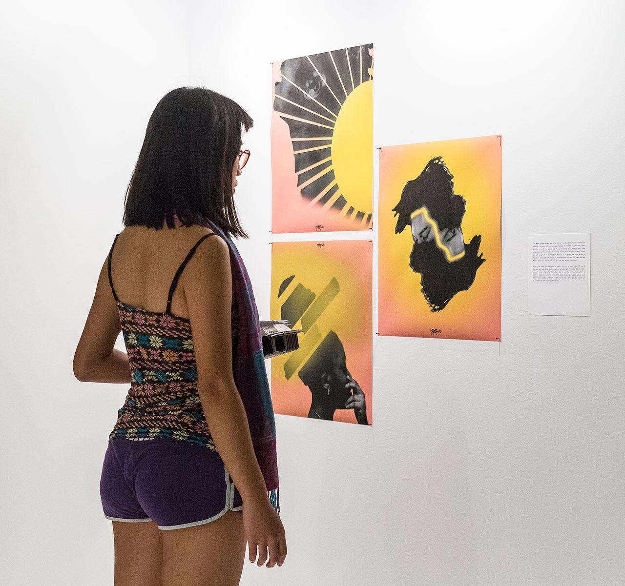 A student looking at artwork in a gallery.