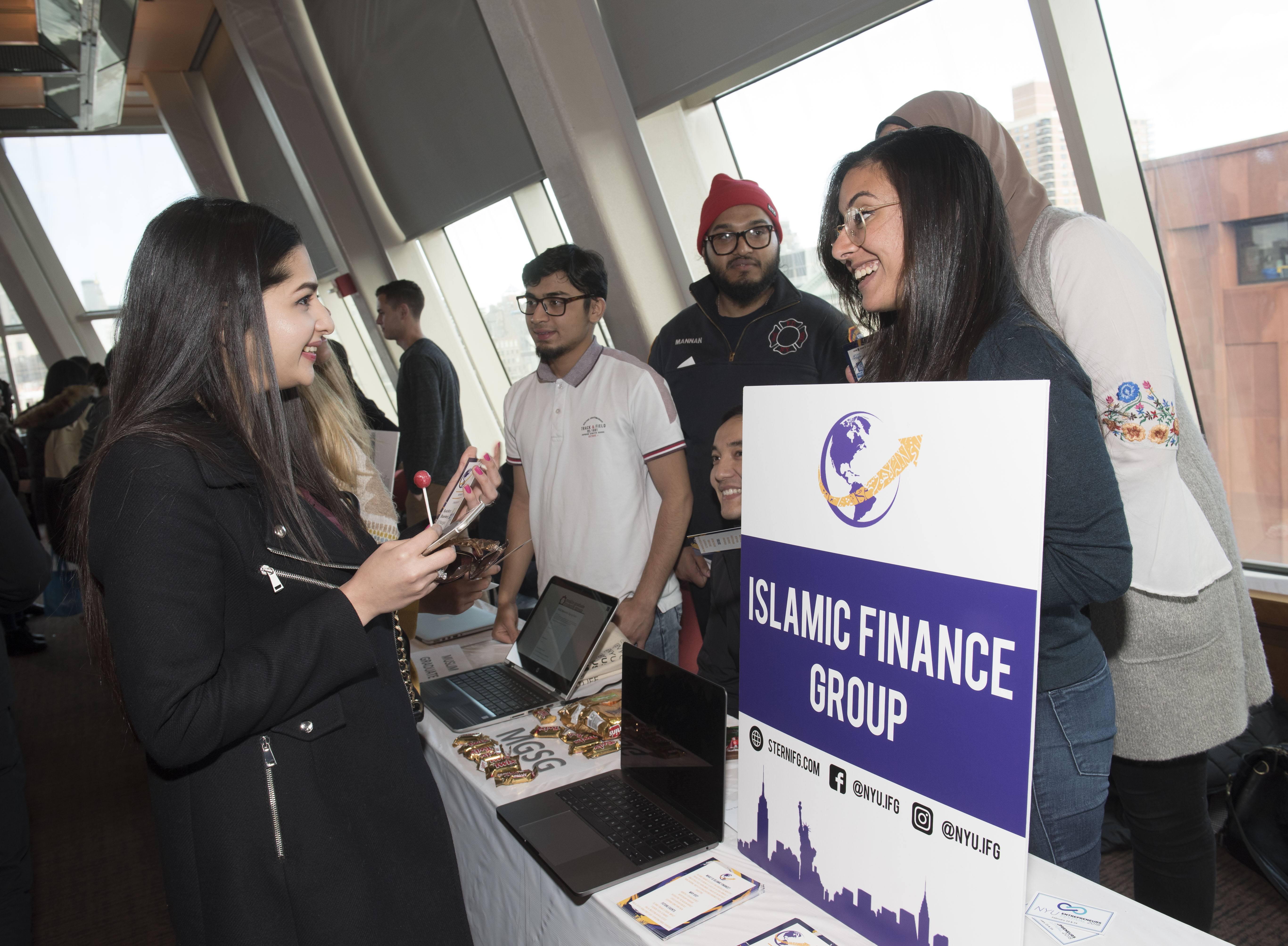 A student visiting a club’s booth at NYU’s Club Fest event.