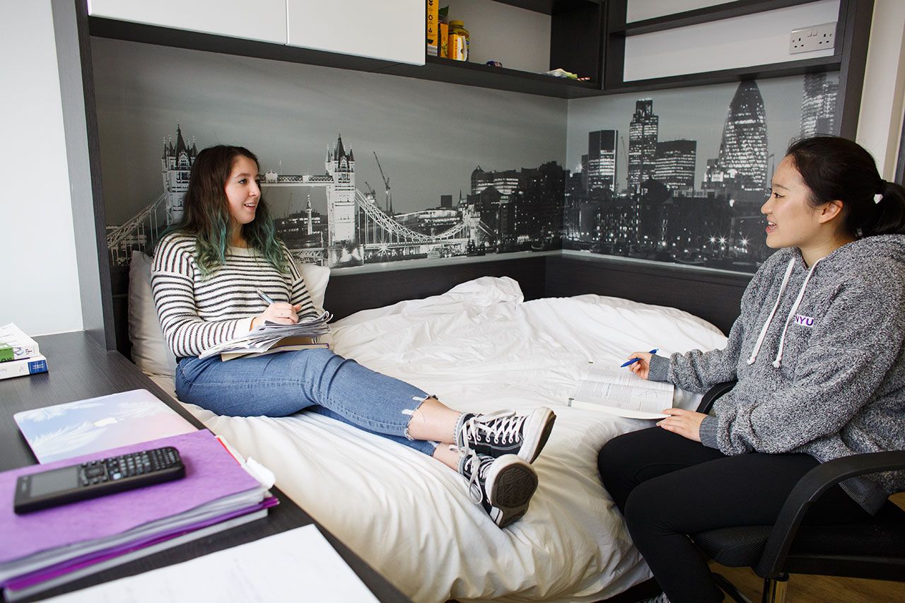 Students hanging out in a dorm room.