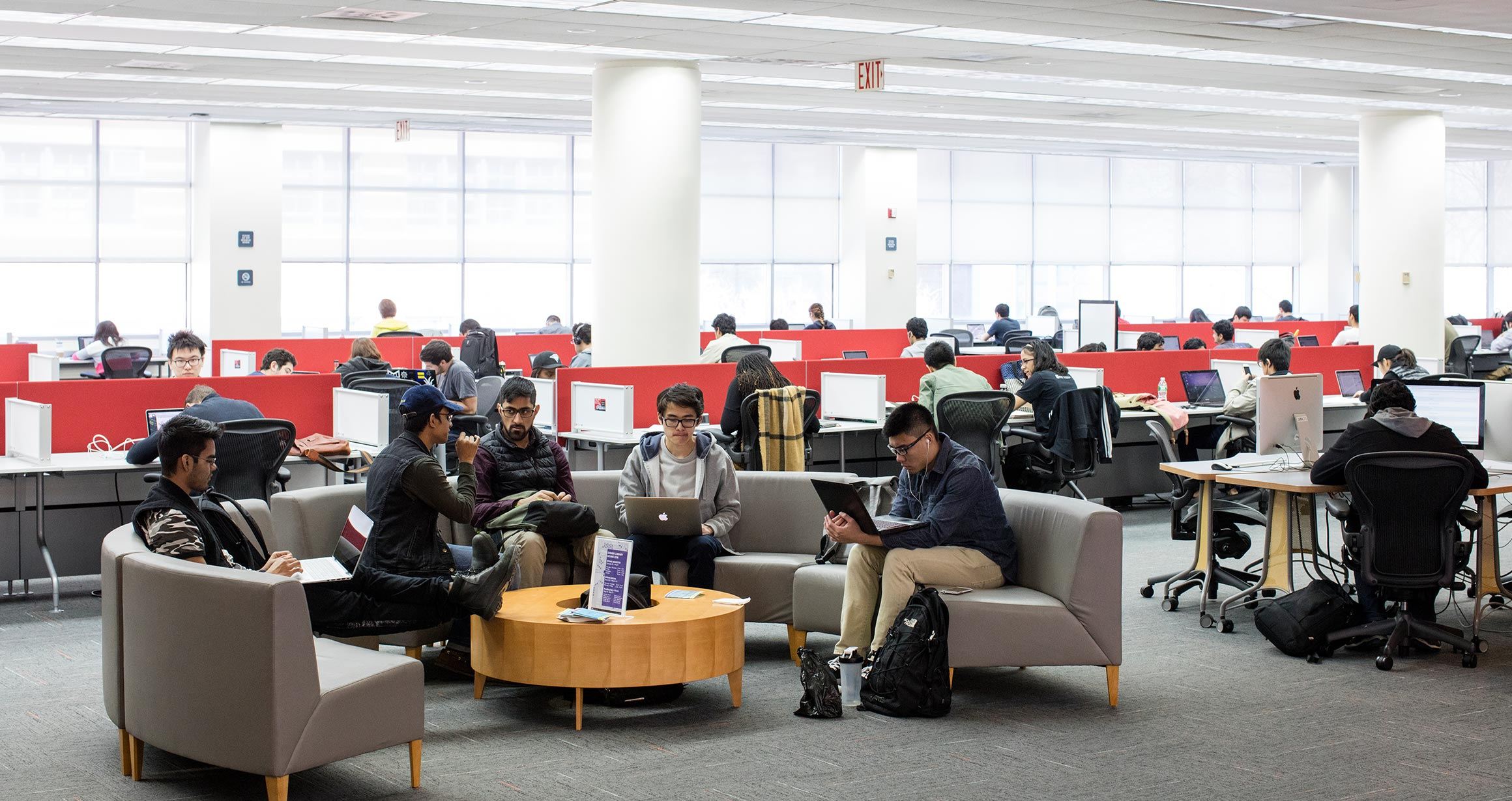 A group of students sit on couches working in the Dibner common area