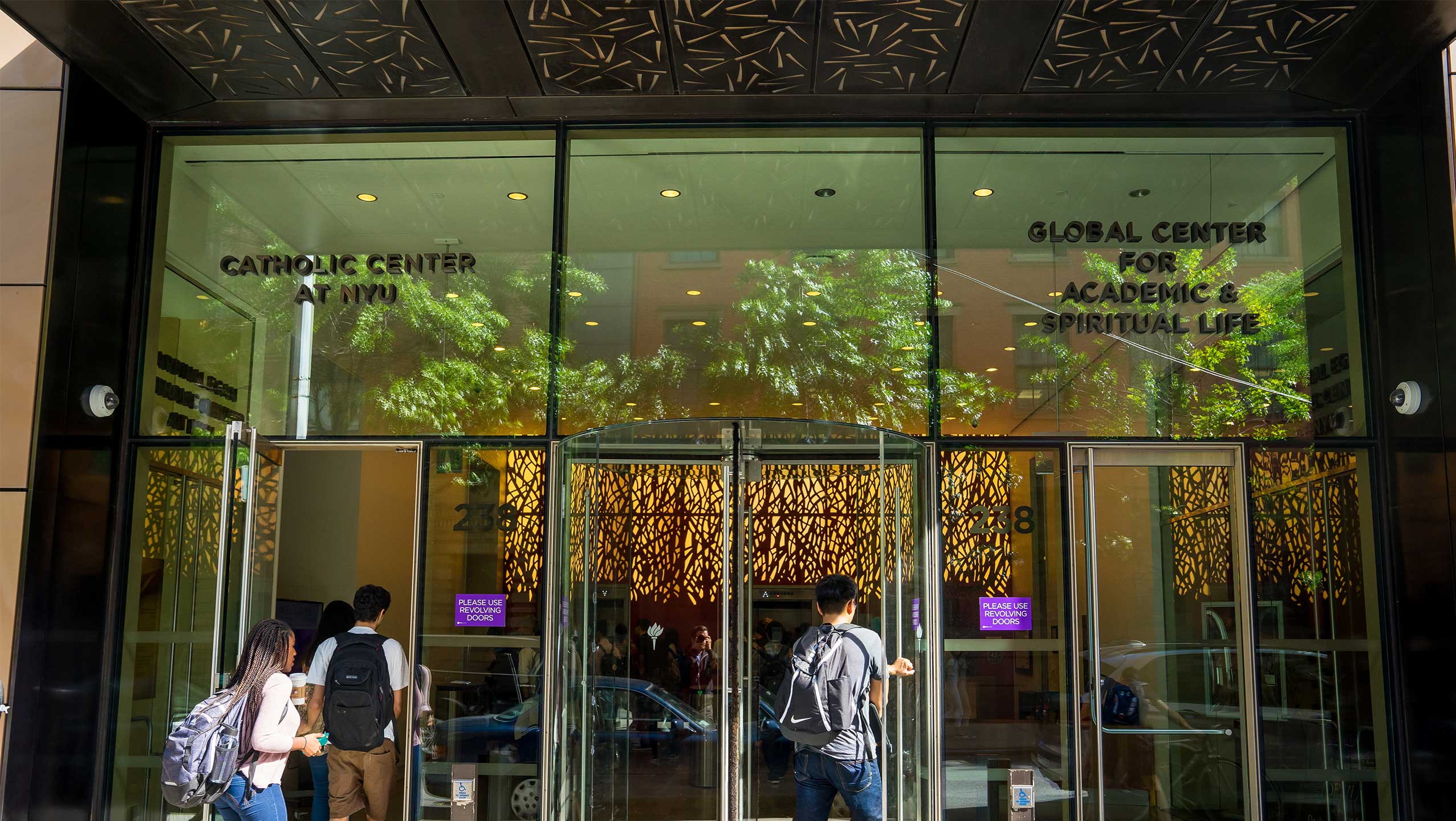 The glass door entrance to the Global Center for Academic and Spiritual Life.