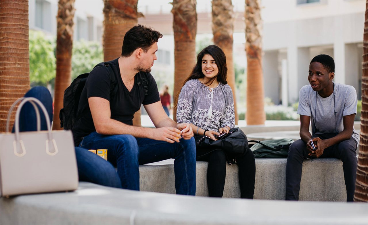 Students sitting and talking in one of NYU Abu Dhabi's many outdoor common areas.
