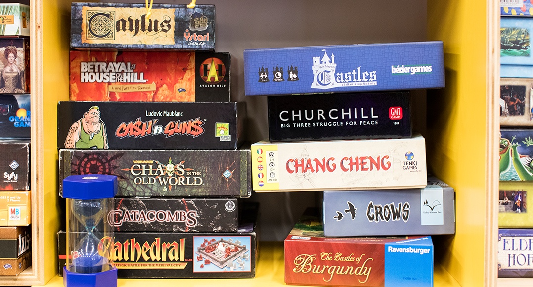 A shelf is filled with board games
