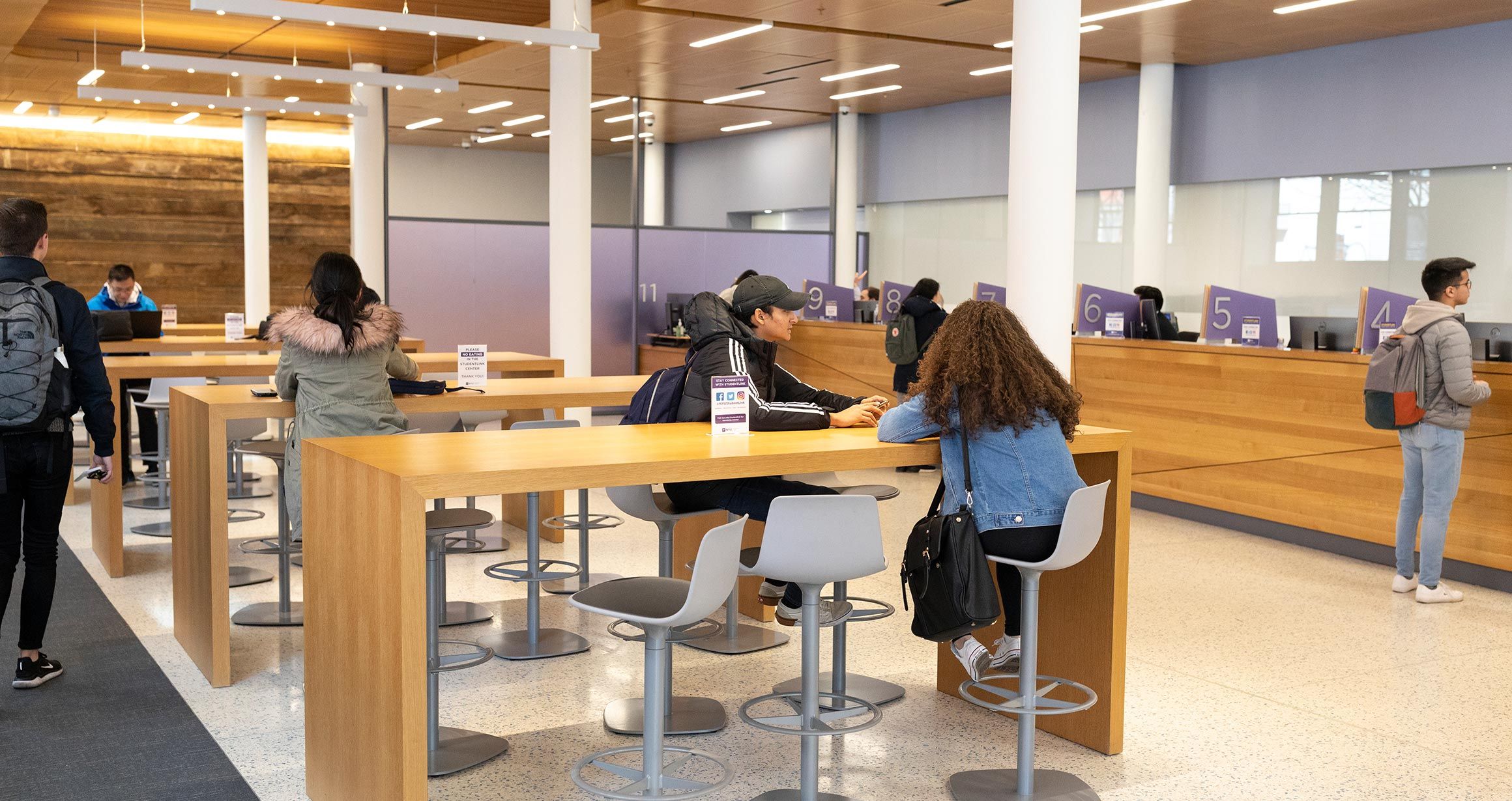 Student sit at the high top tables in the Student Link Center