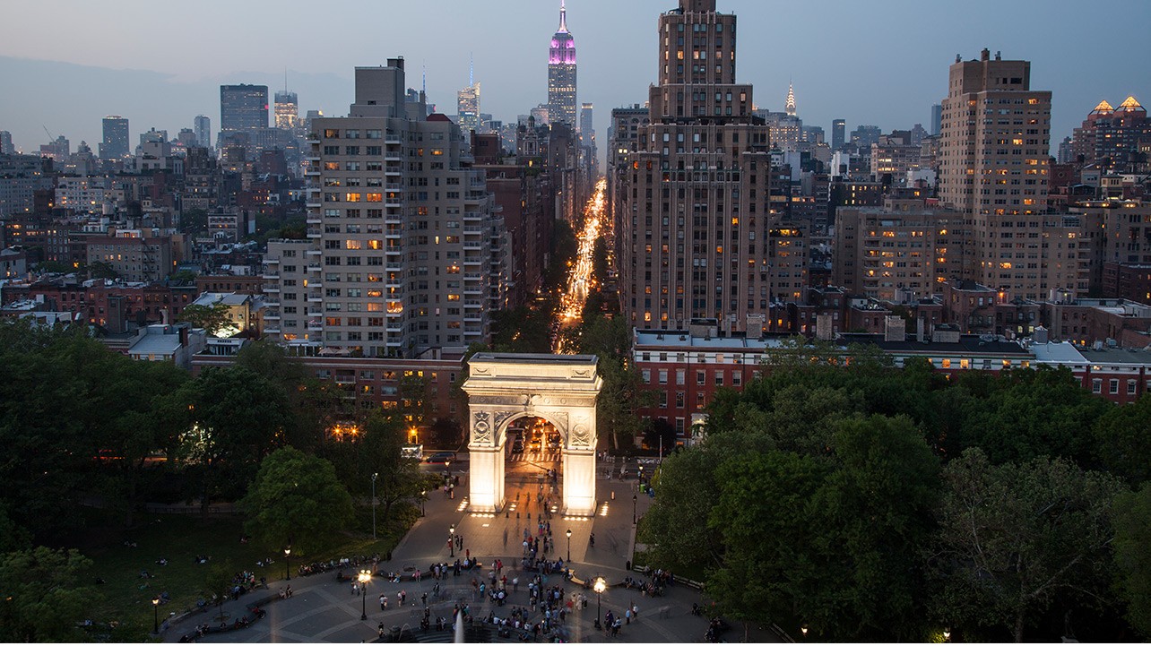 Washington Square Part illuminated at night with the Empire State Building visible