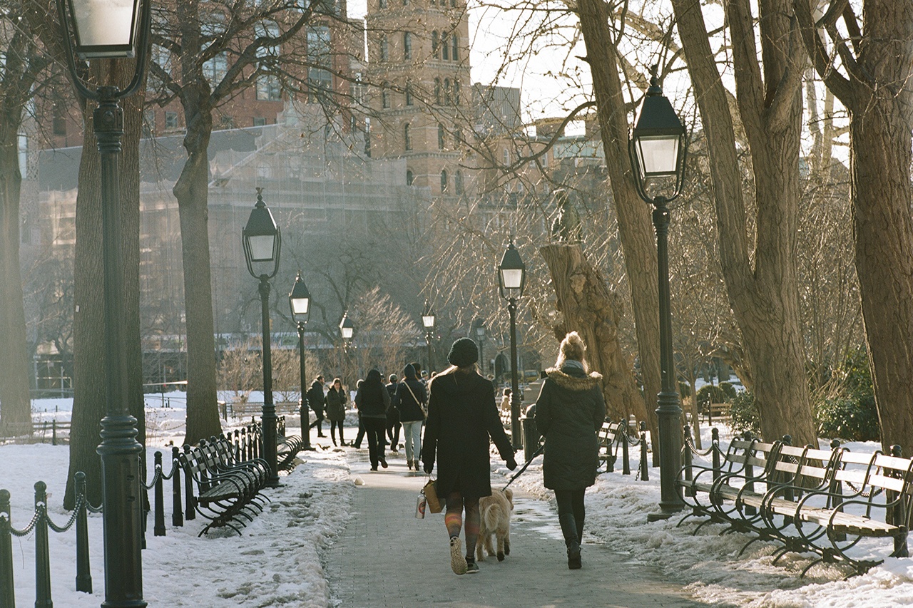 People walking in Washington Square Park in the winter.