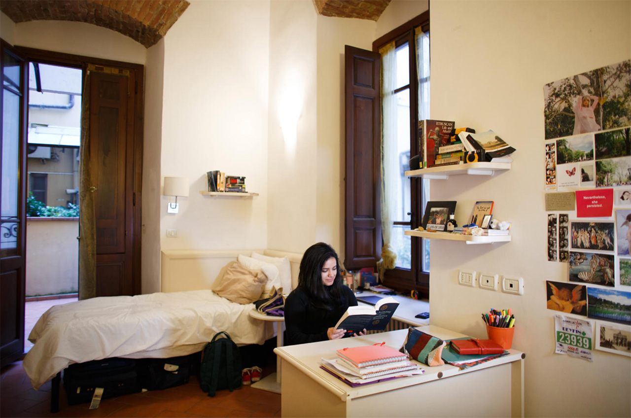 Student reading in a dorm room.