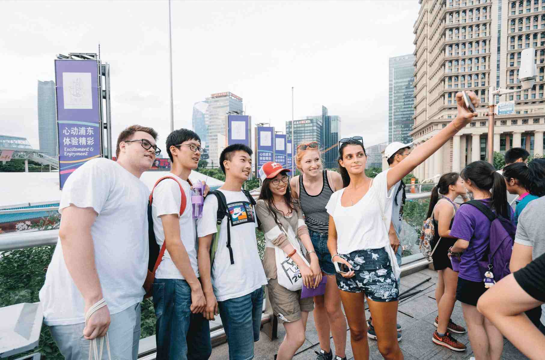a group of people taking a group selfie