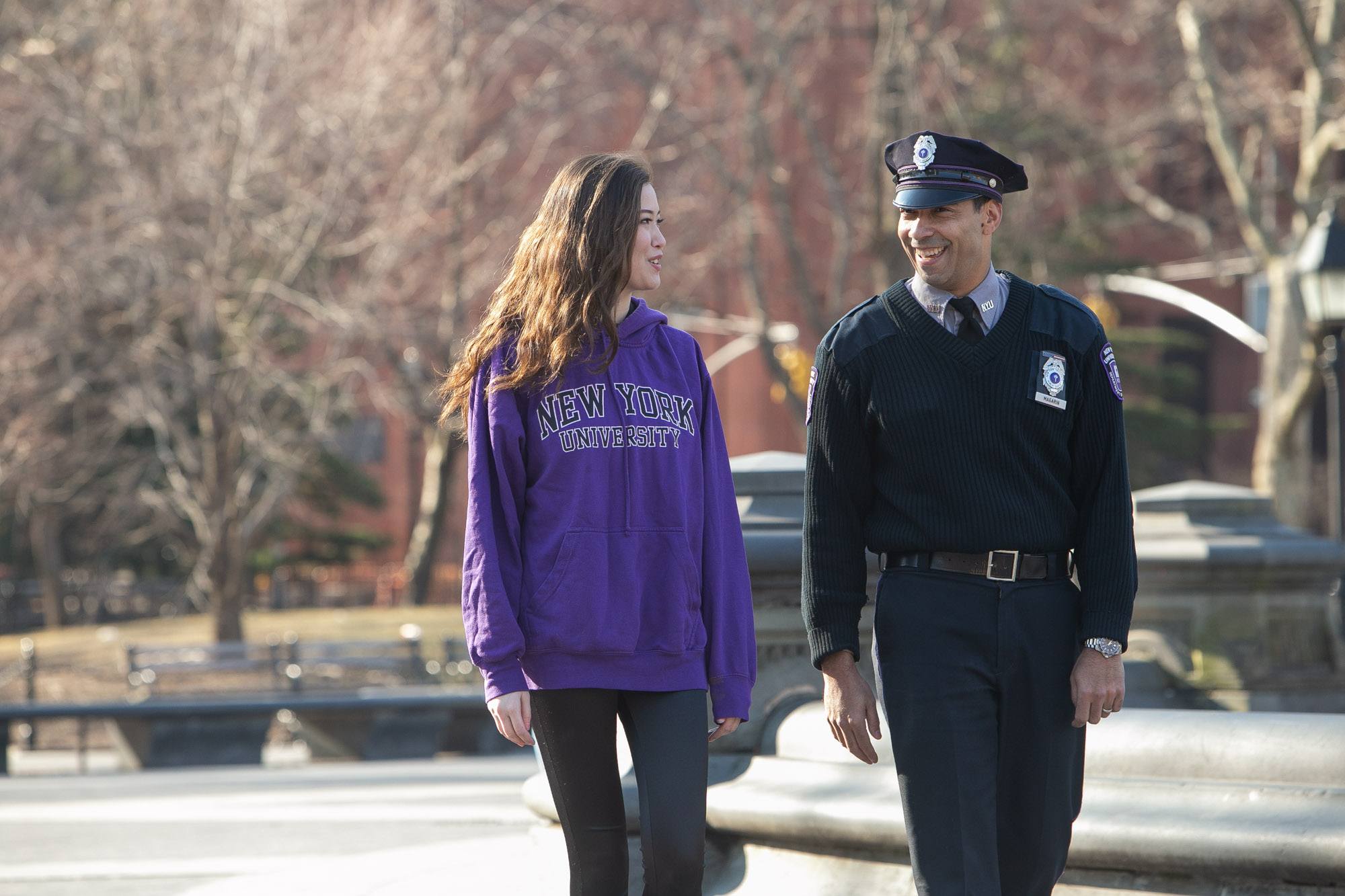 Public safety officer walking and talking with a student