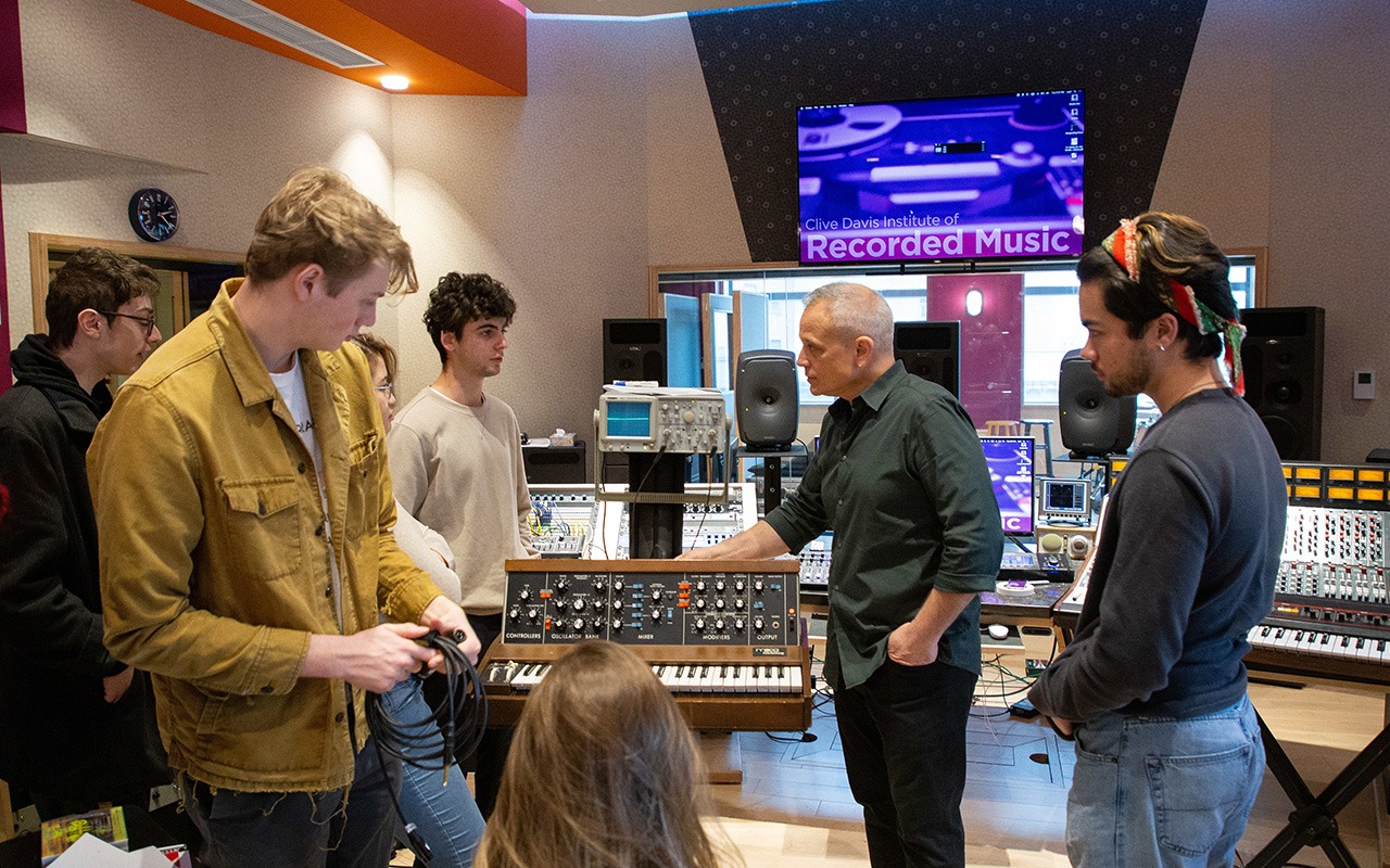 Students working in a recording studio during a recorded music class.