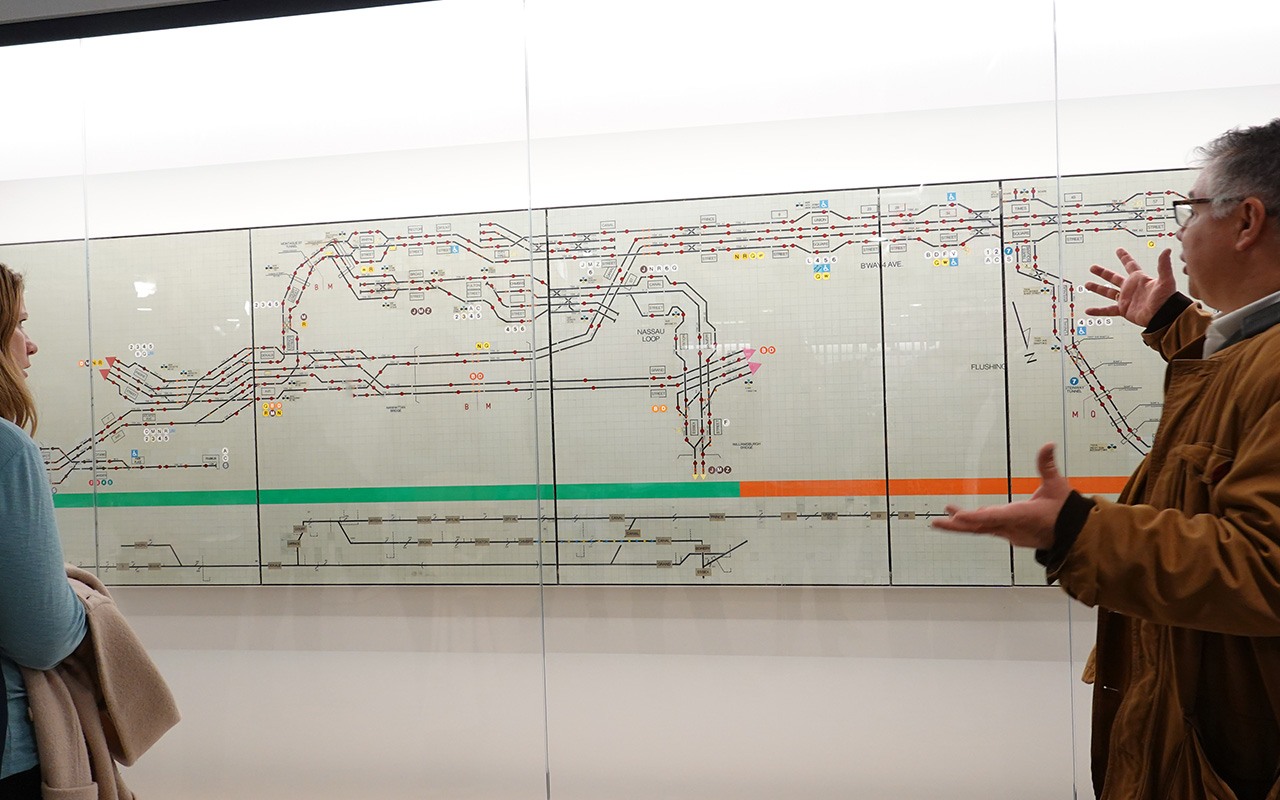 Vintage subway maps displayed in a glass case