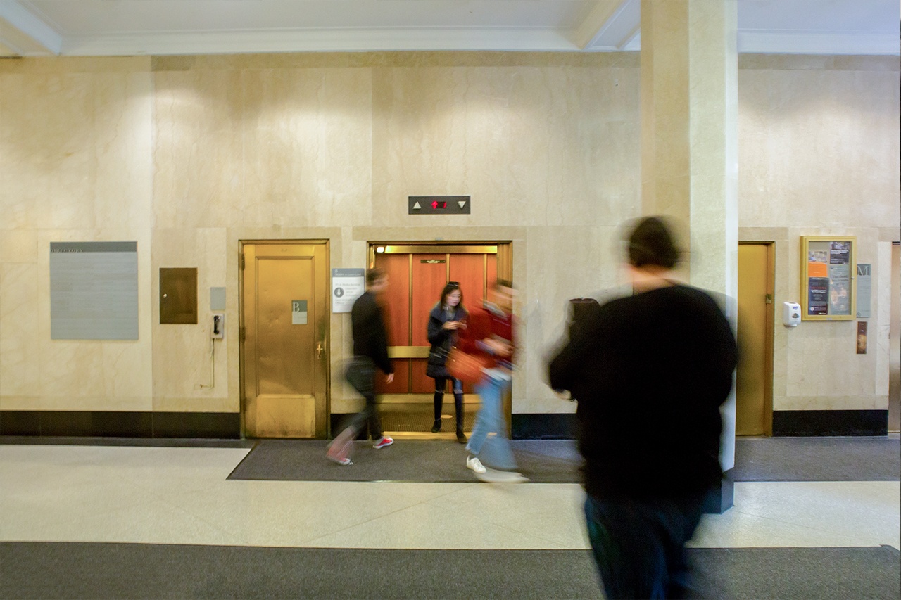 Students leaving and entering an elevator in the Silver Center