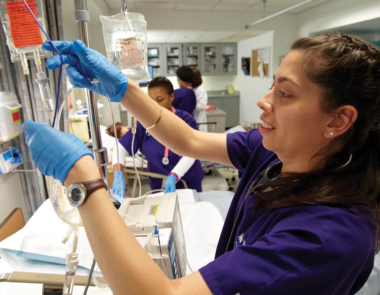 Nursing student putting in an IV drip