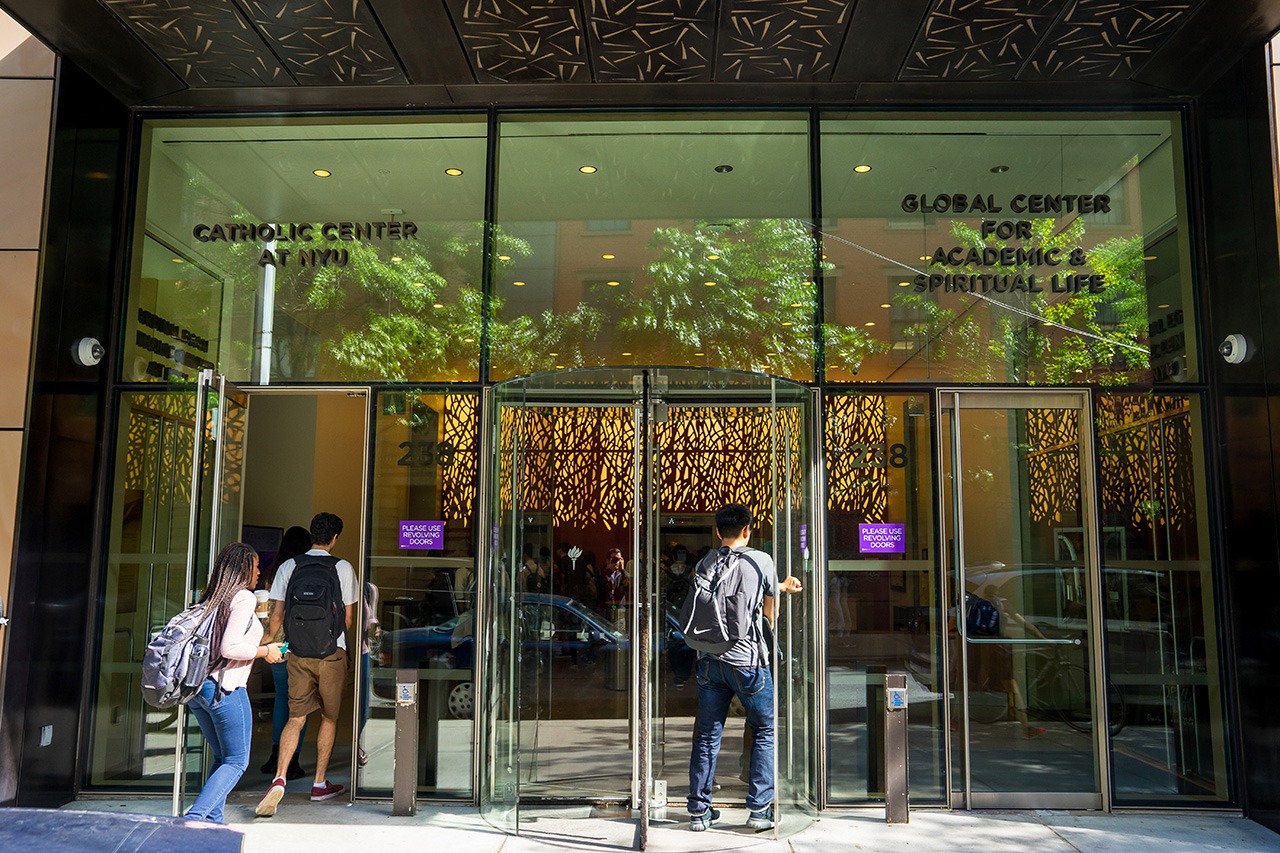 Students entering the NYU Global Center for Academic and Spiritual Life building.