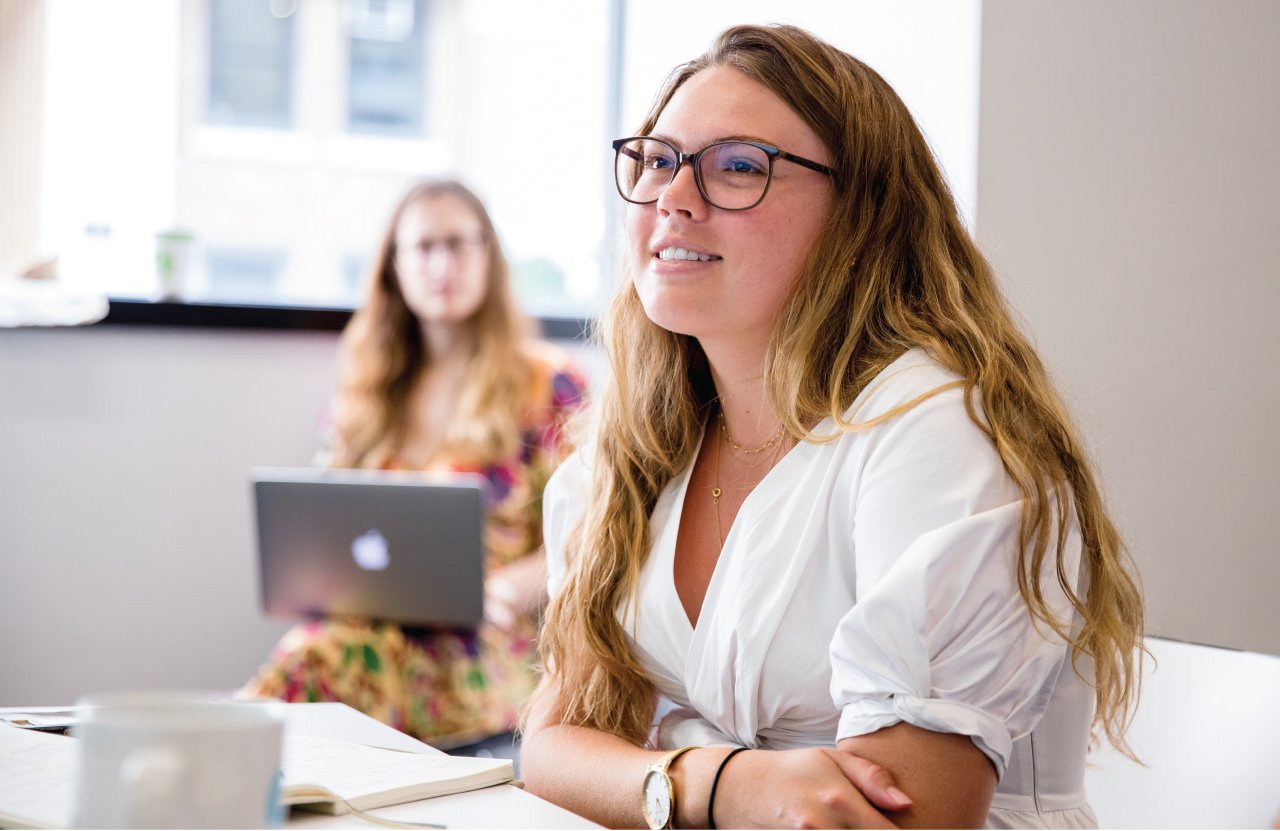 A college student sitting at a desk.