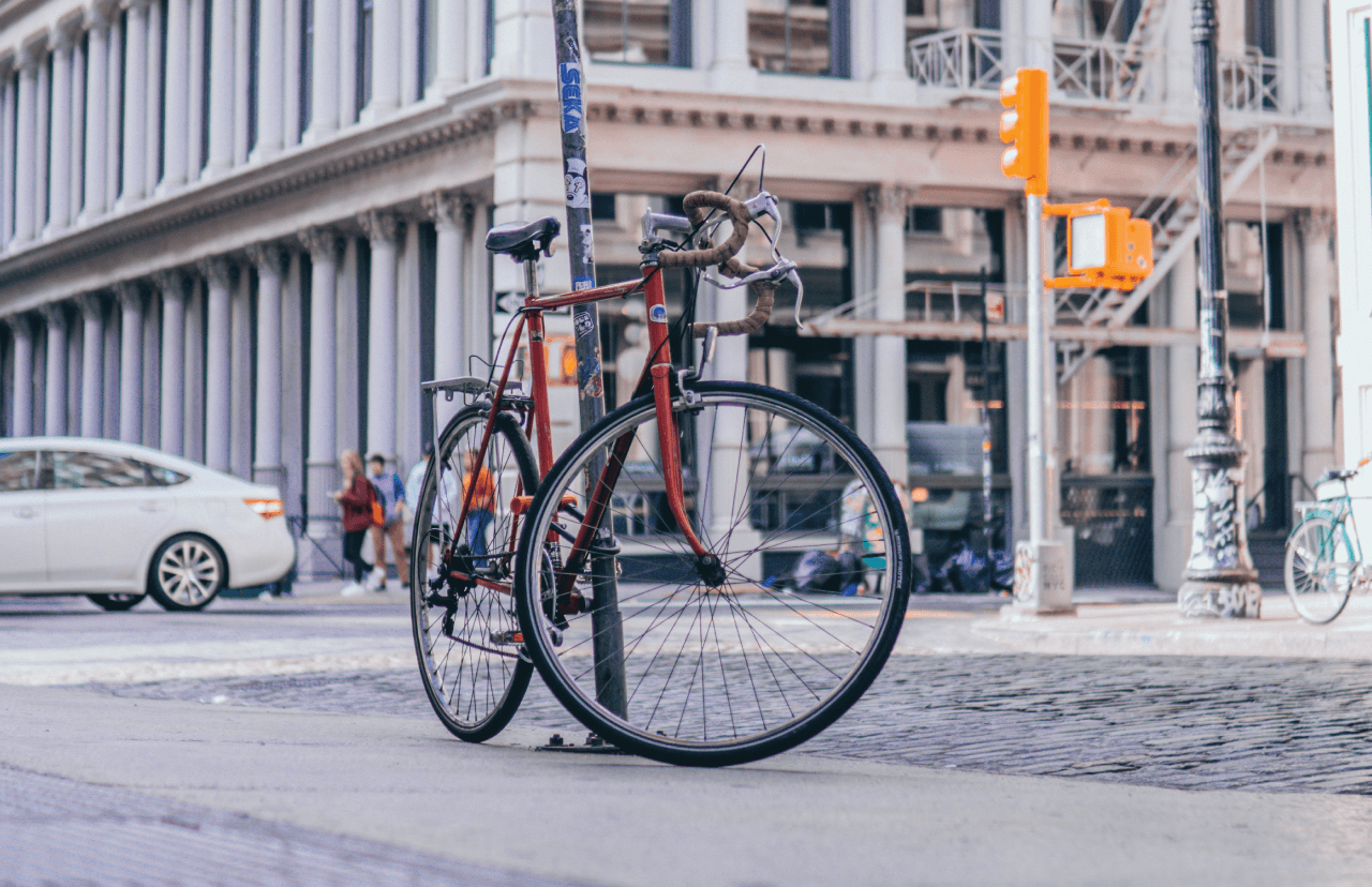 A bike chained to a pole on a New York City street.