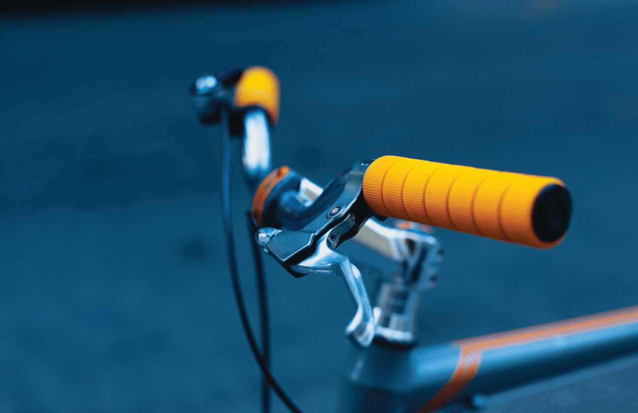 Yellow handlebars on a bike.