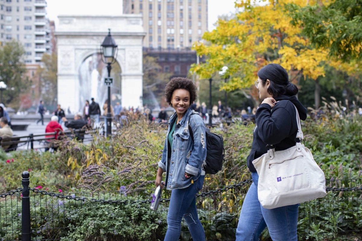 Two students walk in Washington Square Park