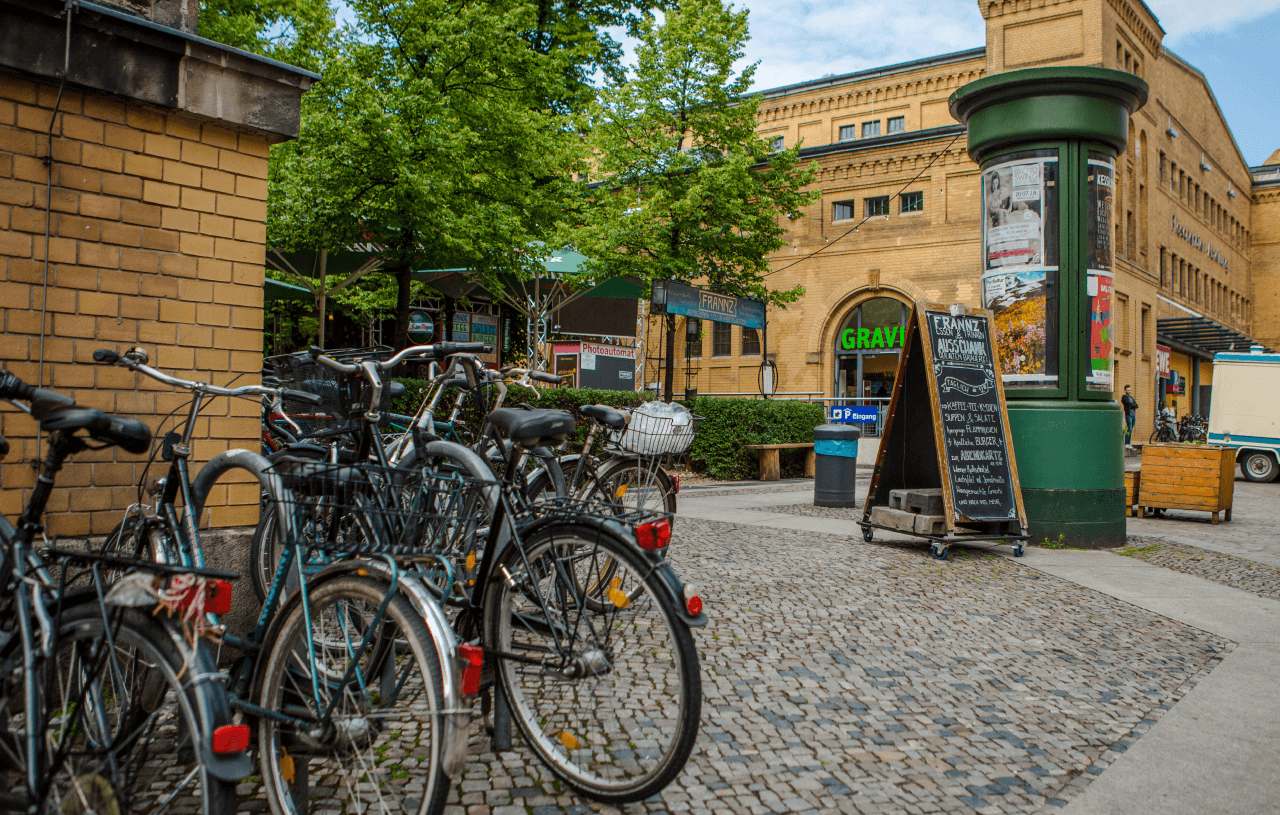 A row of bikes next to an entrance of a building