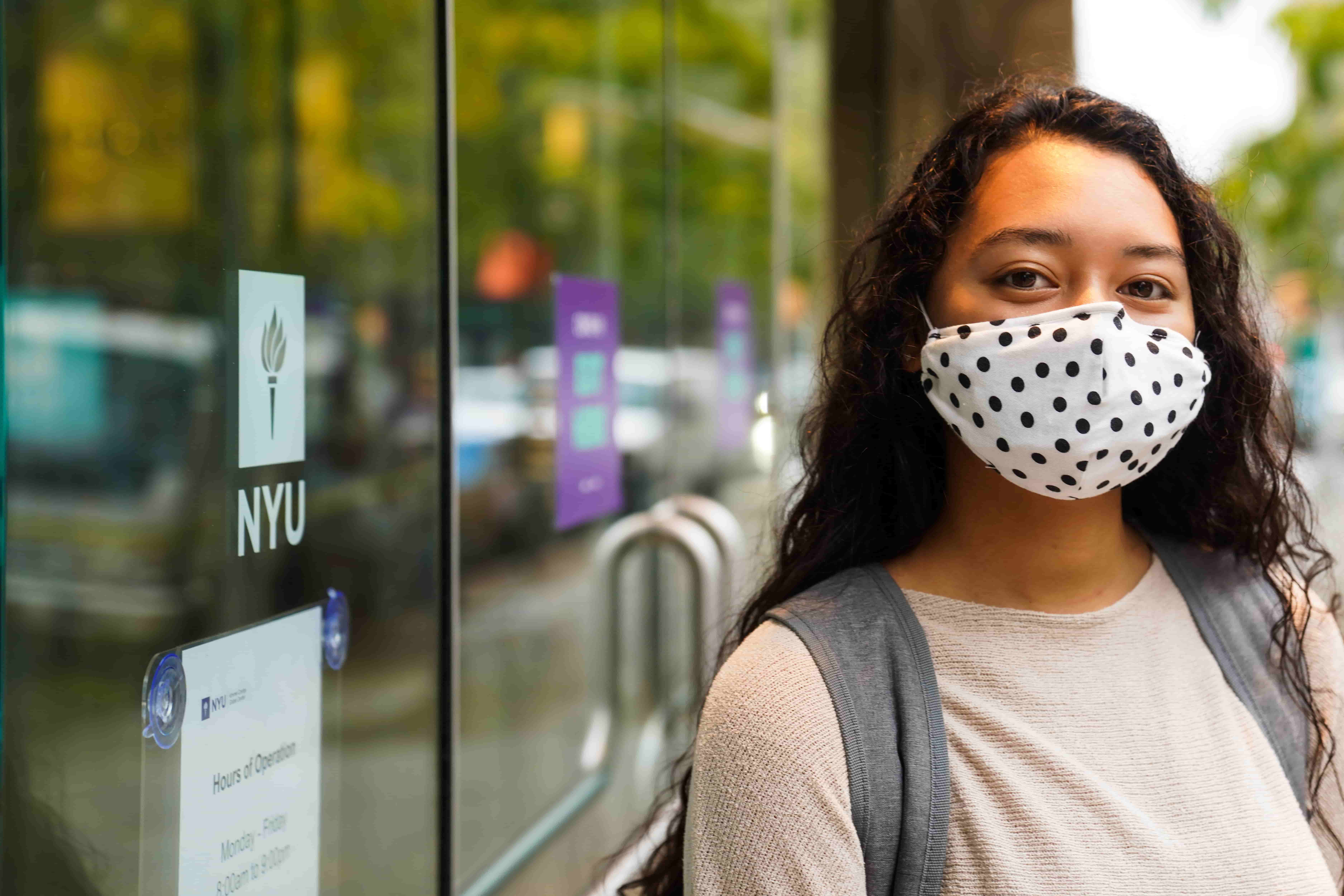 An NYU student wearing a mask.