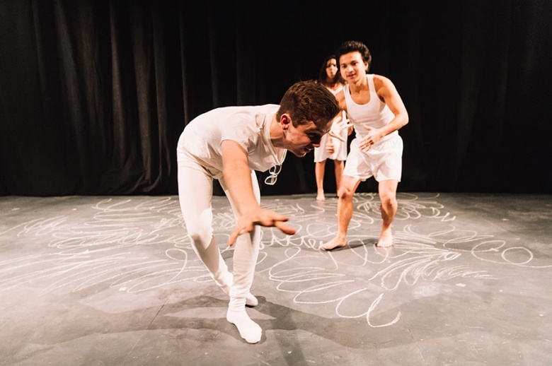 Tisch drama students dressed in white dancing on stage.