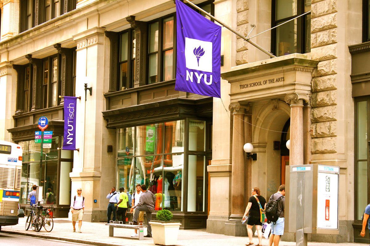 NYU and Tisch flag hanging outside a building.