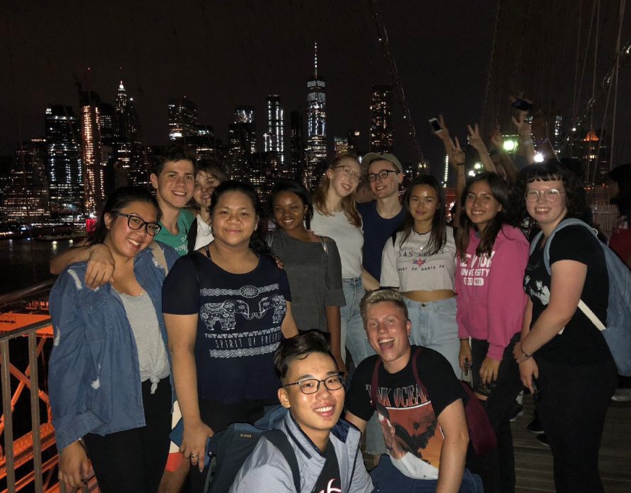 Garet and friends smiling for a photo on a bridge in NYC